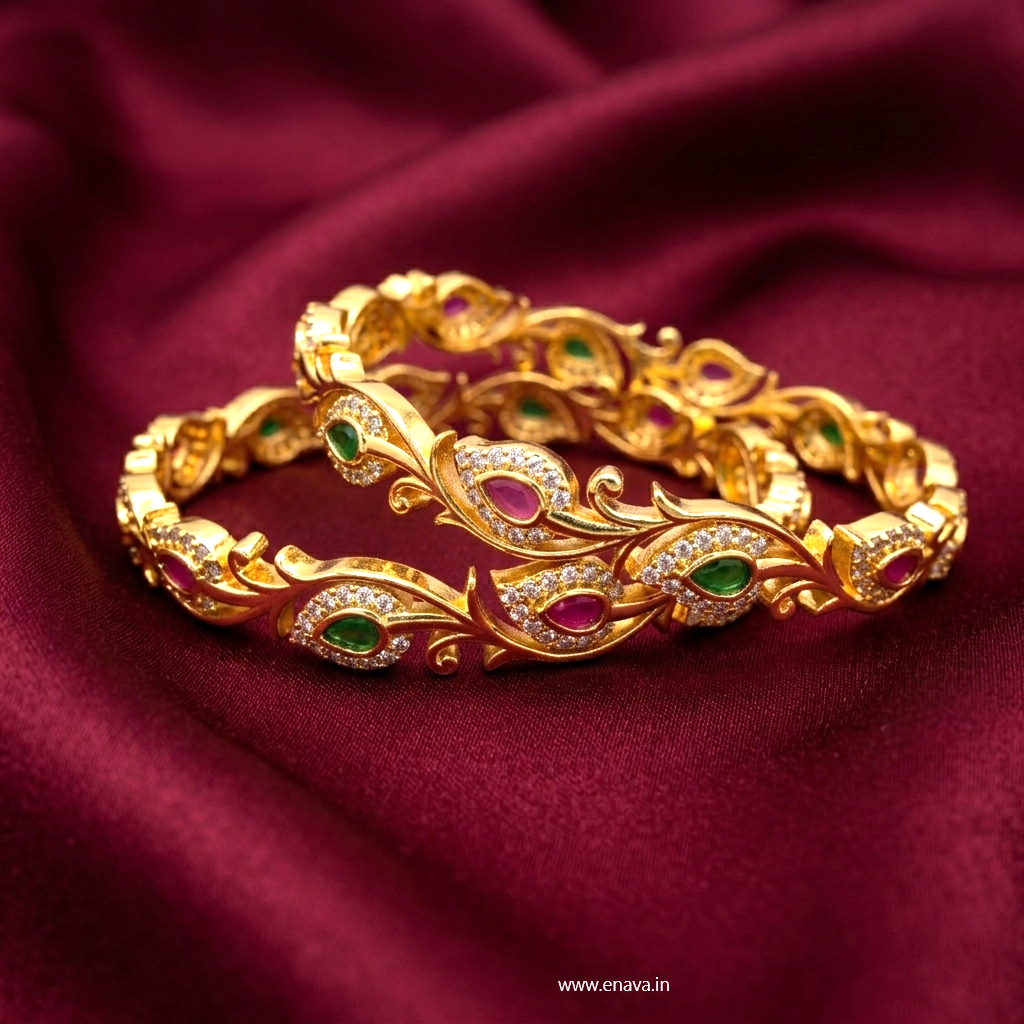 Floral Bliss Gold Plated AD Bangles by ENAVA featuring sparkling Cubic Zirconia AD stones with ruby pink and emerald green teardrop accents in an elegant floral vine design. Premium gold plated bridal bangles perfect for weddings, festive occasions, party wear, and ethnic jewellery collections.