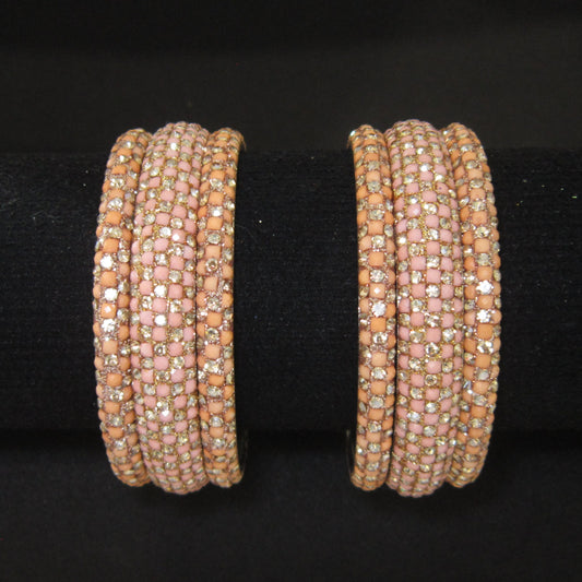 Meher Light Peach Festive Bangle Set with 2 kada bangles and 4 side bangles featuring light peach detailing, golden accents and sparkling stones by ENAVA
