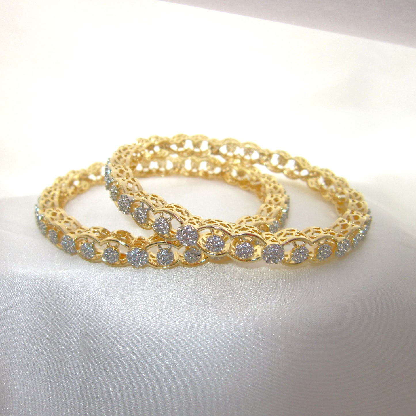 Orbit Gold Plated CZ AD Bangles by ENAVA with sparkling white Cubic Zirconia American Diamonds, premium gold plated designer AD bangles featuring an elegant orbit pattern, perfect for bridal wear, weddings, festive occasions, party wear jewellery, and ethnic fashion.