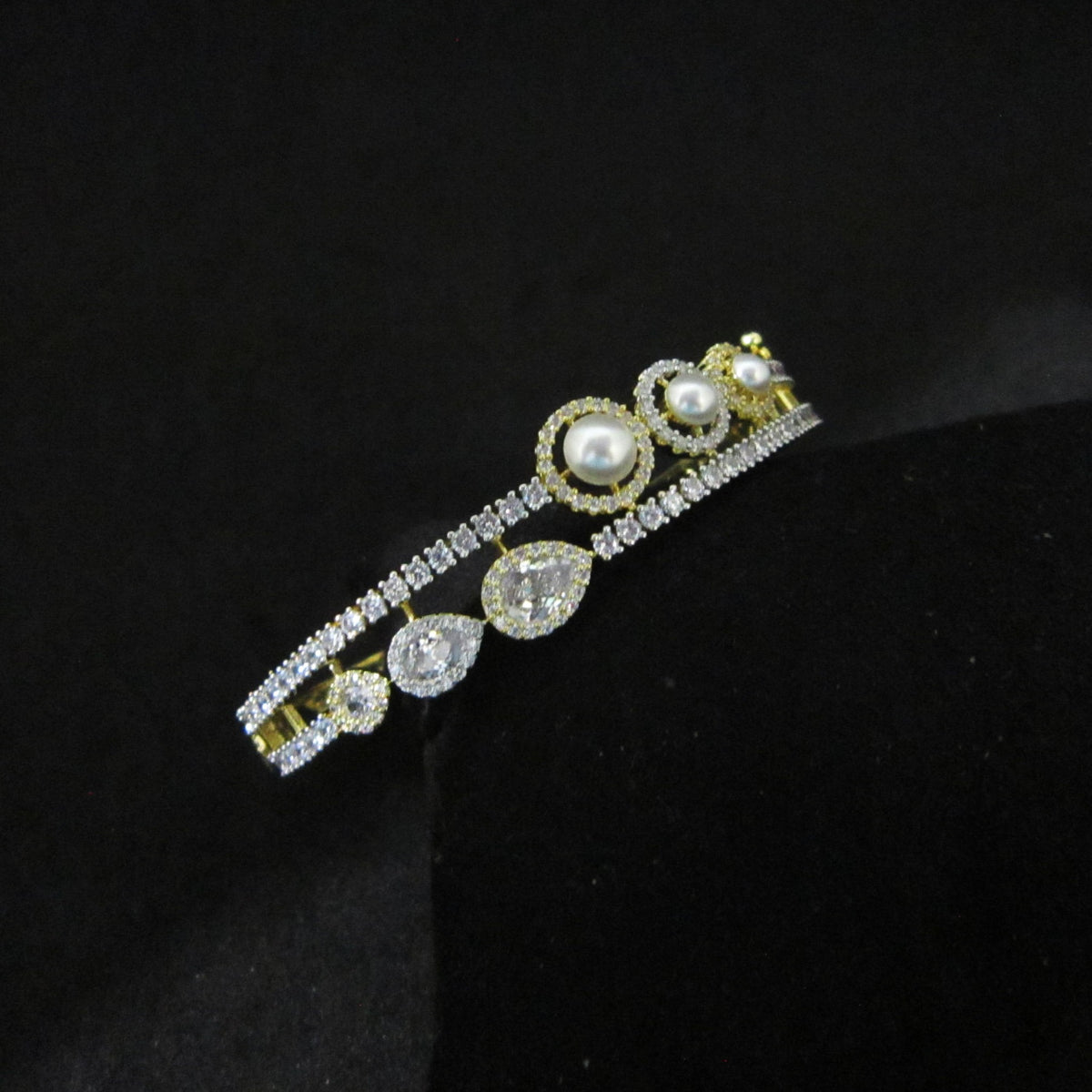 Pearl Oasis AD Bracelet with pearls, sparkling American Diamond stones and drop-shaped center AD in dual-tone finish, designer pearl bracelet for women by ENAVA.