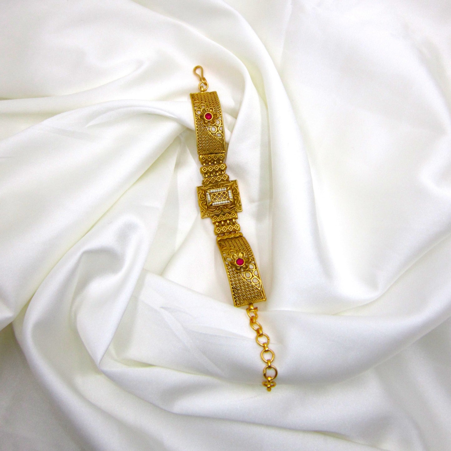 Traditional Rajwadi bracelet by ENAVA featuring antique gold detailing, pearl-inspired centerpiece, heritage craftsmanship, and luxury bridal jewellery aesthetics.