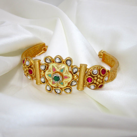 Avani Meena Ethnic & Traditional Golden Bracelet by ENAVA featuring floral Meenakari design, kundan-style stones, ruby and green accents, traditional Rajwadi heritage jewellery with elegant golden finish for weddings and festive wear.