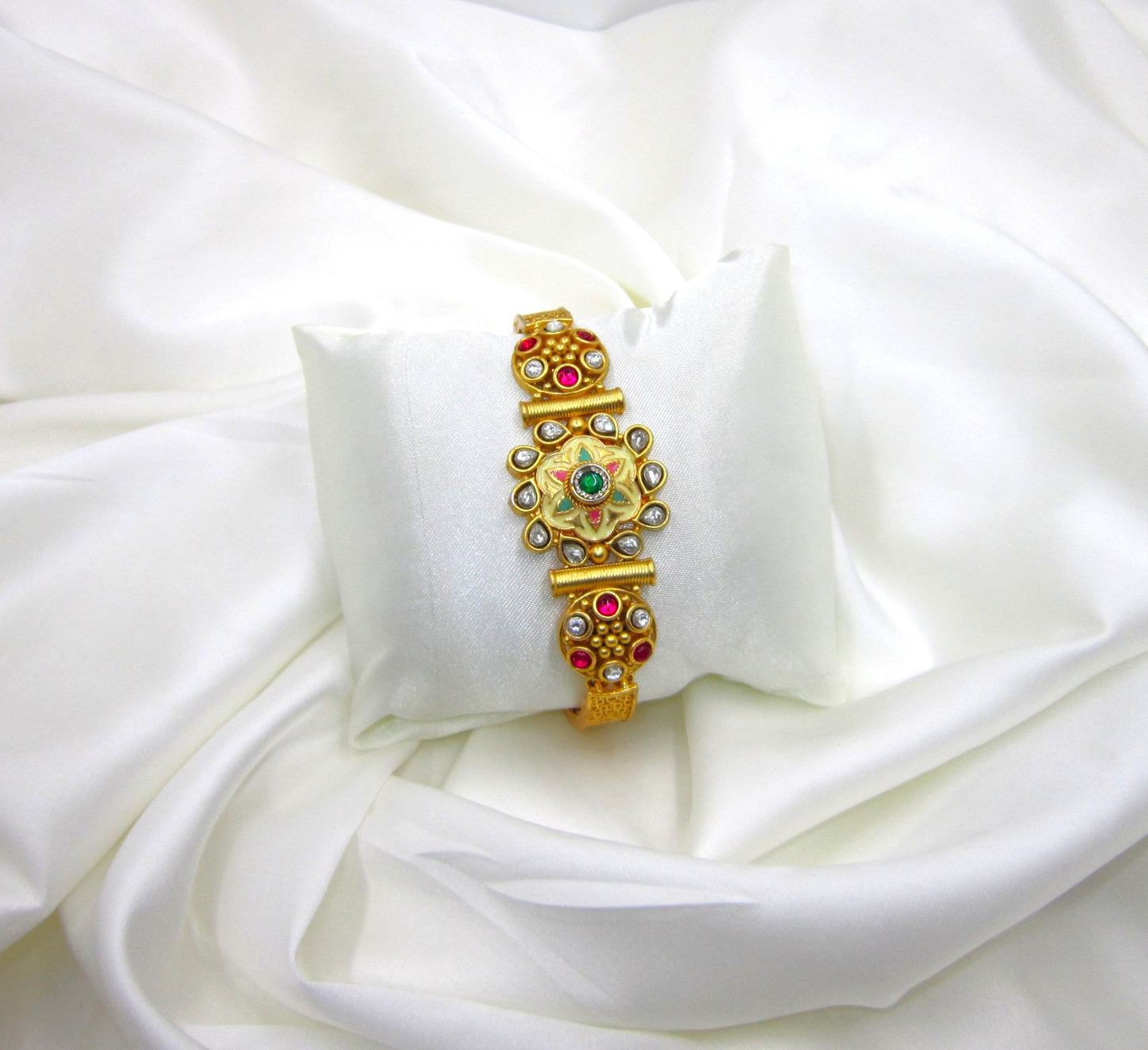 Avani Meena Ethnic & Traditional Golden Bracelet by ENAVA featuring floral Meenakari design, kundan-style stones, ruby and green accents, traditional Rajwadi heritage jewellery with elegant golden finish for weddings and festive wear.
