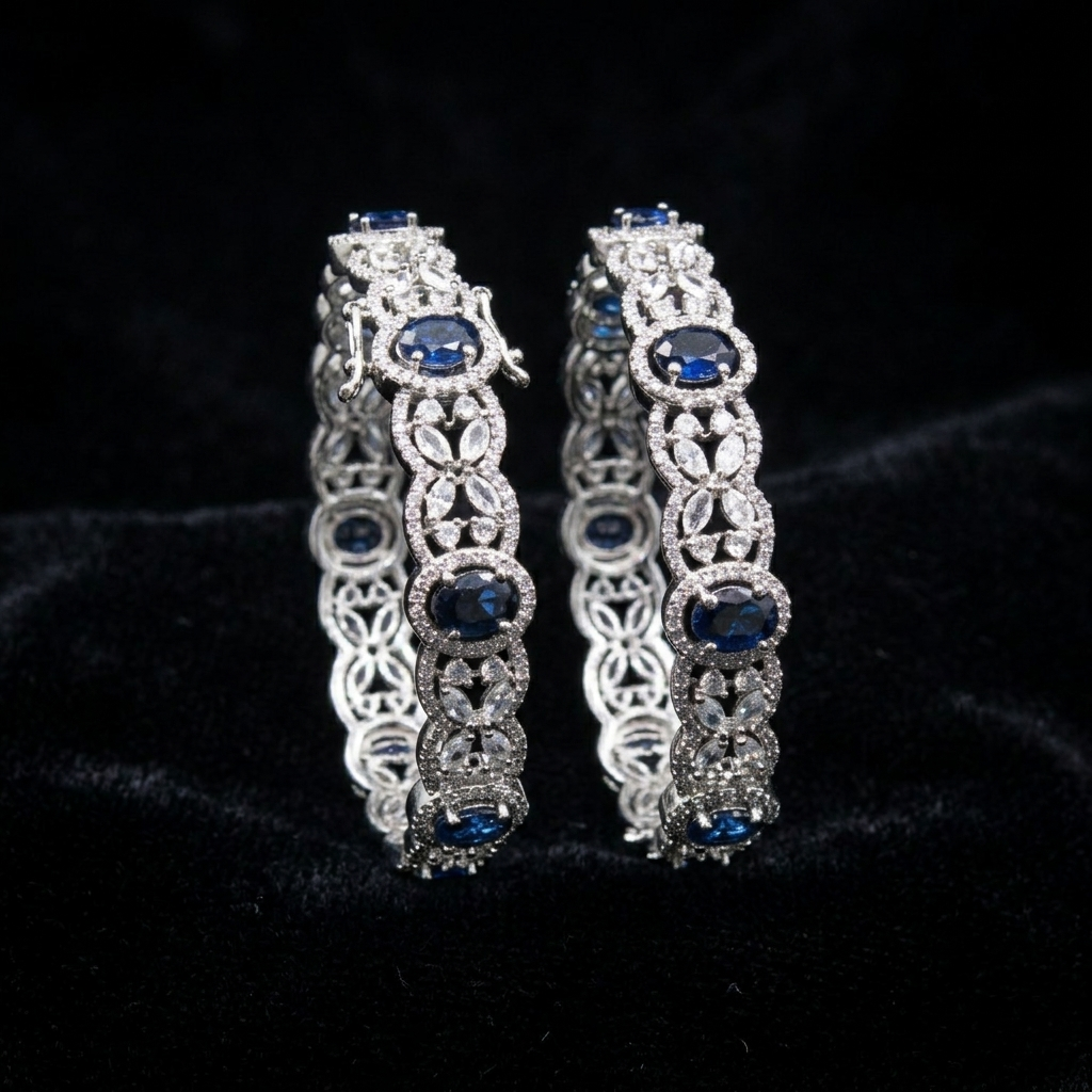 Celestial Blue Victoria AD Silver Plated Bangles by ENAVA featuring sparkling American Diamonds, floral detailing, and elegant blue stones. Premium silver-plated designer bangles for weddings, festive occasions, receptions, and party wear.