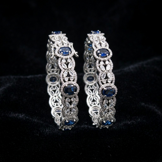 Celestial Blue Victoria AD Silver Plated Bangles by ENAVA featuring sparkling American Diamonds, floral detailing, and elegant blue stones. Premium silver-plated designer bangles for weddings, festive occasions, receptions, and party wear.