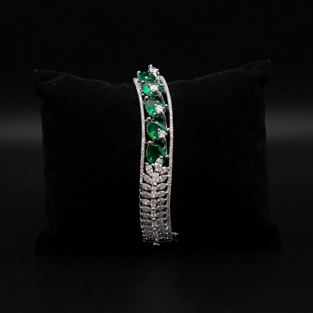 Emerald Dreams Sparkling AD Bracelet with wavy curve design, sparkling American Diamond stones and emerald green stone motifs, elegant designer bracelet for women by ENAVA.