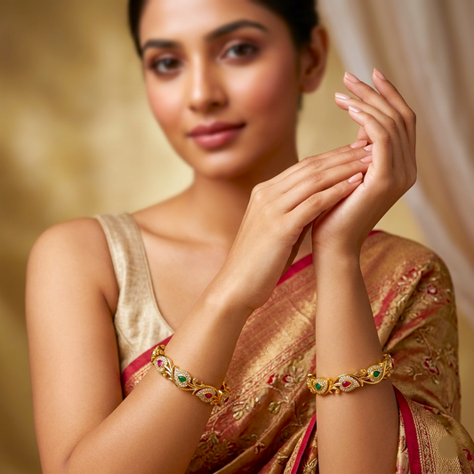 Floral Bliss Gold Plated AD Bangles by ENAVA featuring sparkling Cubic Zirconia AD stones with ruby pink and emerald green teardrop accents in an elegant floral vine design. Premium gold plated bridal bangles perfect for weddings, festive occasions, party wear, and ethnic jewellery collections.