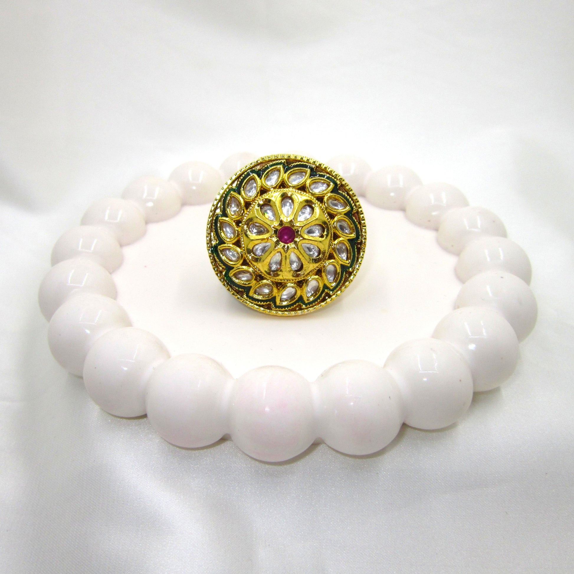 Green Meenakari Heritage Kundan Gold Ring by Enava featuring traditional teardrop Kundan stones, intricate green meenakari detailing, ruby-inspired centre stone, high gold finish, adjustable ethnic statement ring for weddings, festive wear, and traditional Indian jewellery.