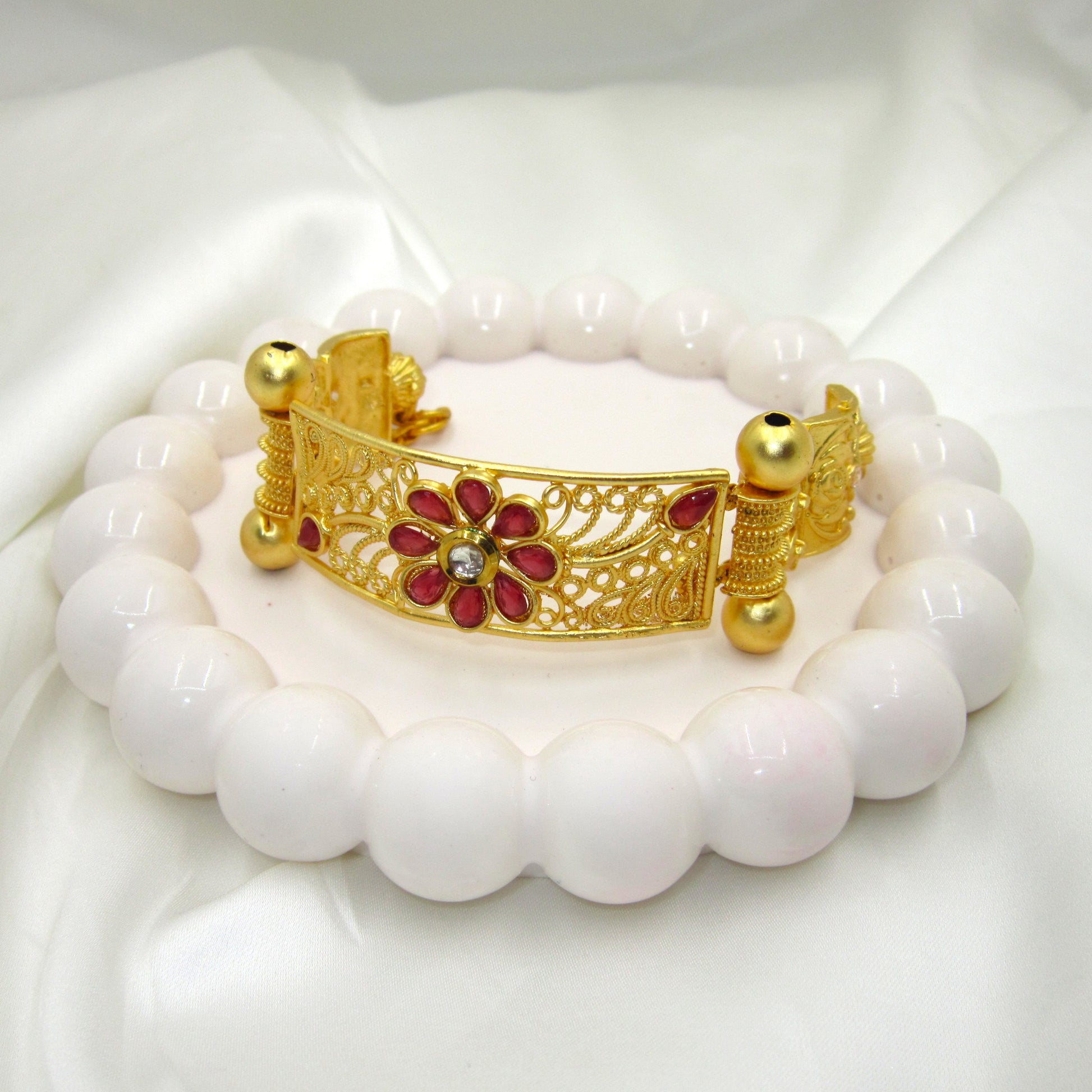 Premium Gulnaar Rajwadi Kada Bracelet by Enava with ruby red flower design, filigree patterns, antique gold finish, and handcrafted ethnic jewellery styling.