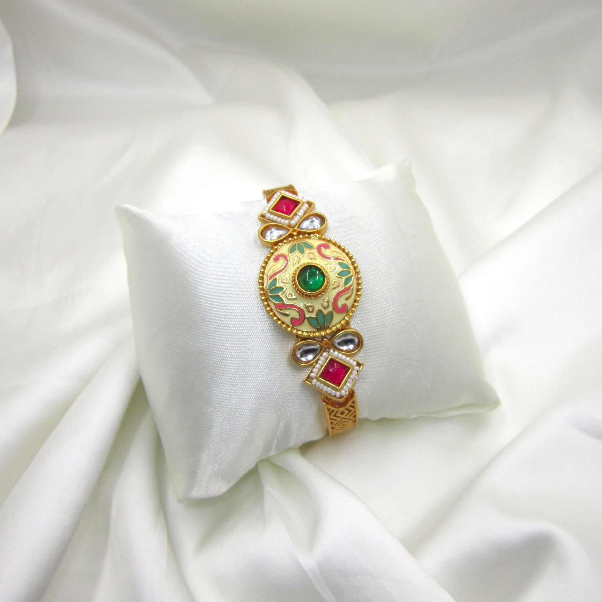 Kalashini Emerald Green Enamel Bracelet by Enava featuring a circular Kundan centerpiece with hand-painted emerald green Meenakari enamel, antique gold finish, adjustable closure, and a premium ethnic statement bracelet for weddings, festive celebrations, and traditional wear.