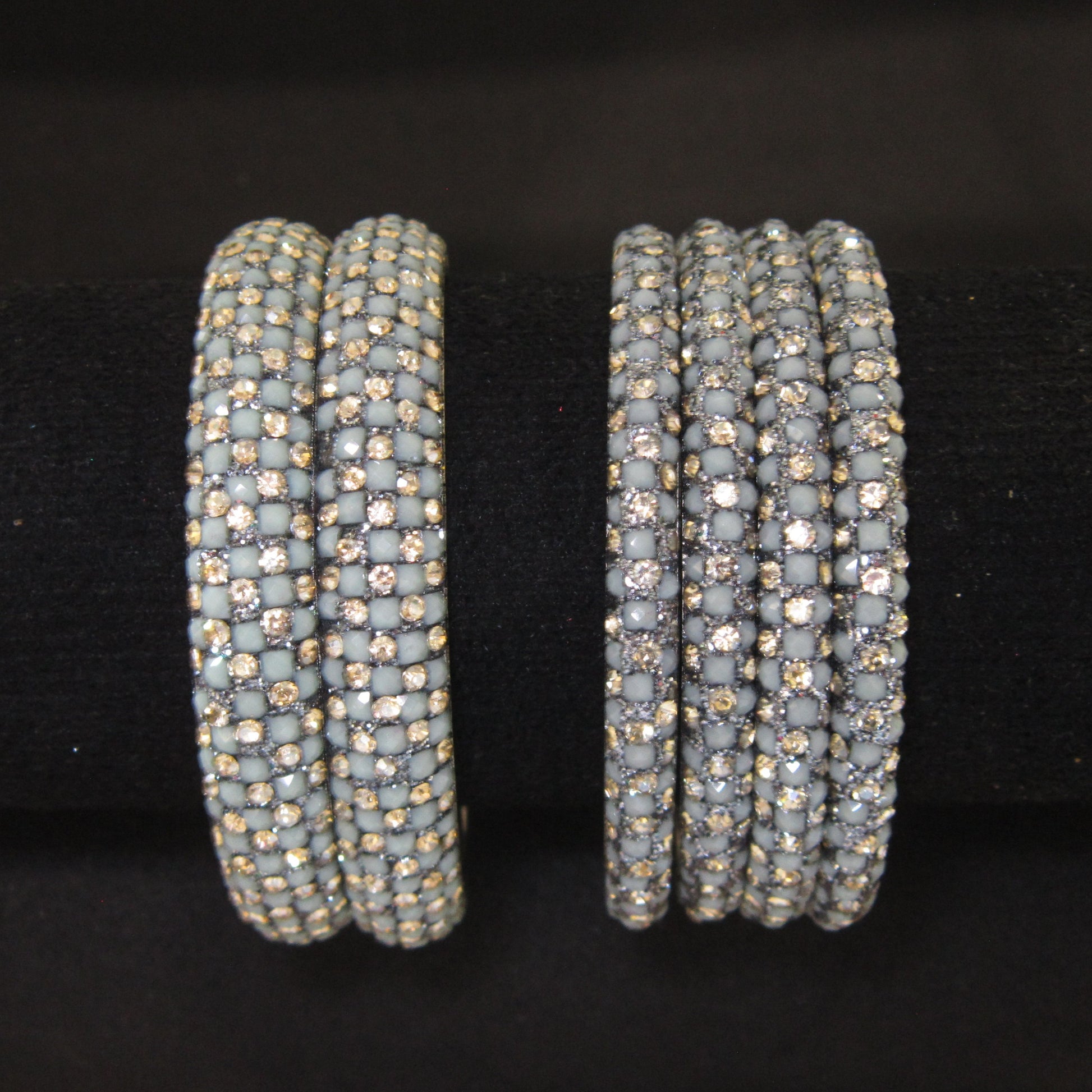 Meher Grey Festive Bangle Set with 2 kada bangles and 4 side bangles featuring grey detailing, golden accents and sparkling stones by ENAVA