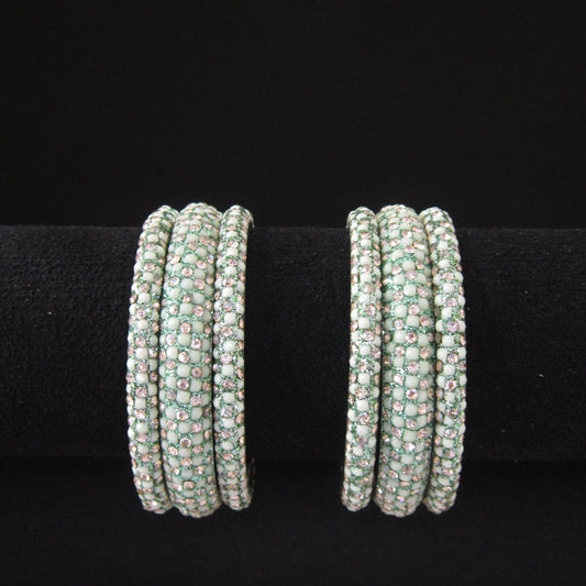 Meher Light Pista Festive Bangle Set with 2 kada bangles and 4 side bangles featuring light pista green detailing, golden accents and sparkling stones by ENAVA