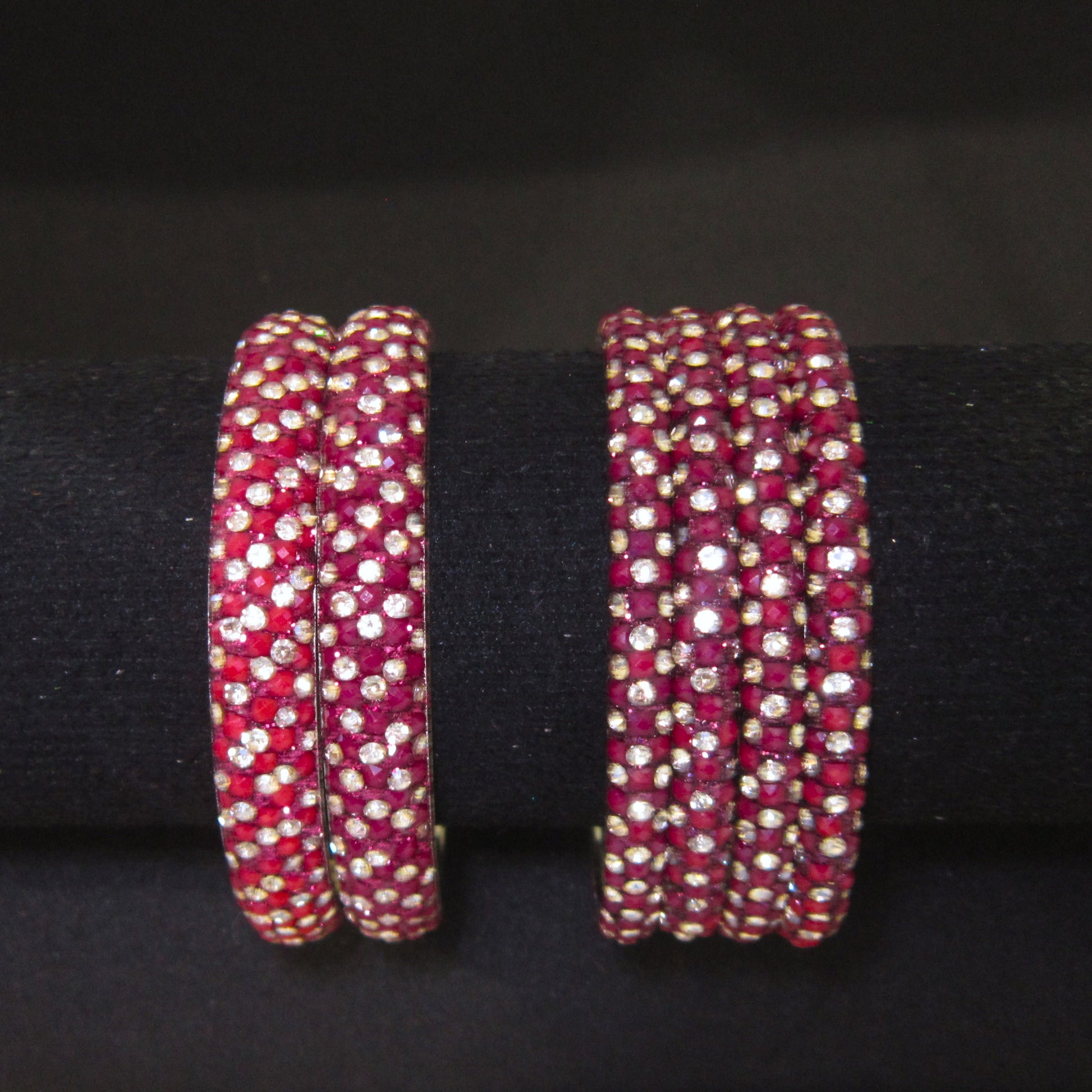 Meher Maroon Festive Bangle Set with 2 kada bangles and 4 side bangles featuring maroon detailing, golden accents and sparkling stones by ENAVA