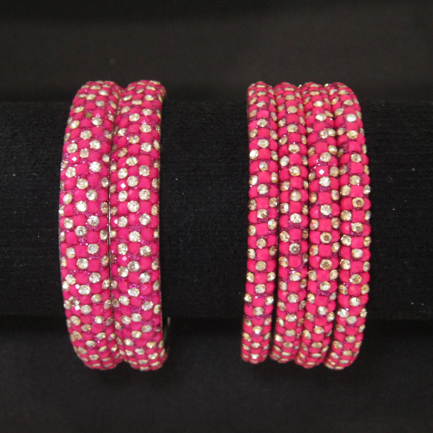 Meher Rani Pink Festive Bangle Set with 2 kada bangles and 4 side bangles featuring rani pink detailing, golden accents and sparkling stones by ENAVA