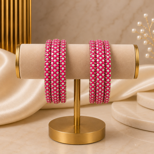 Meher Rani Pink Festive Bangle Set with 2 kada bangles and 4 side bangles featuring rani pink detailing, golden accents and sparkling stones by ENAVA