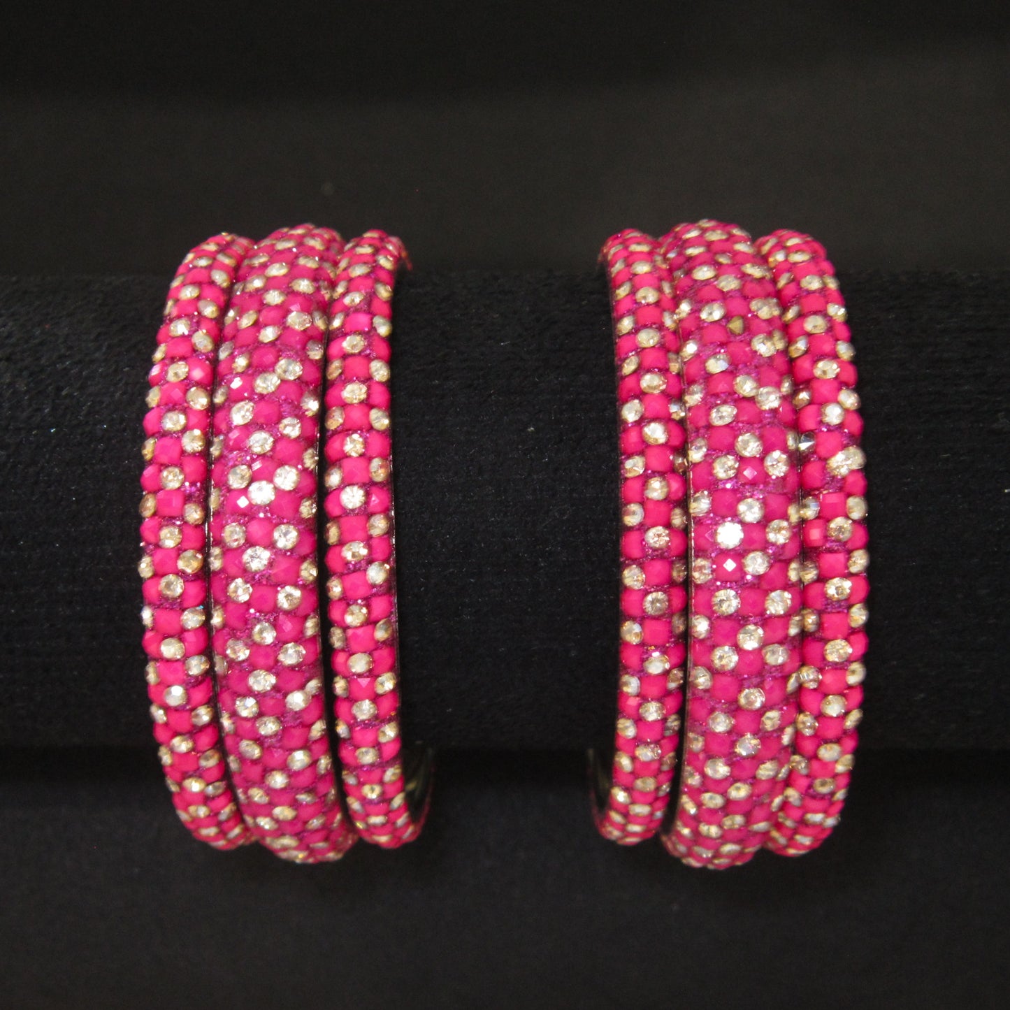 Meher Rani Pink Festive Bangle Set with 2 kada bangles and 4 side bangles featuring rani pink detailing, golden accents and sparkling stones by ENAVA