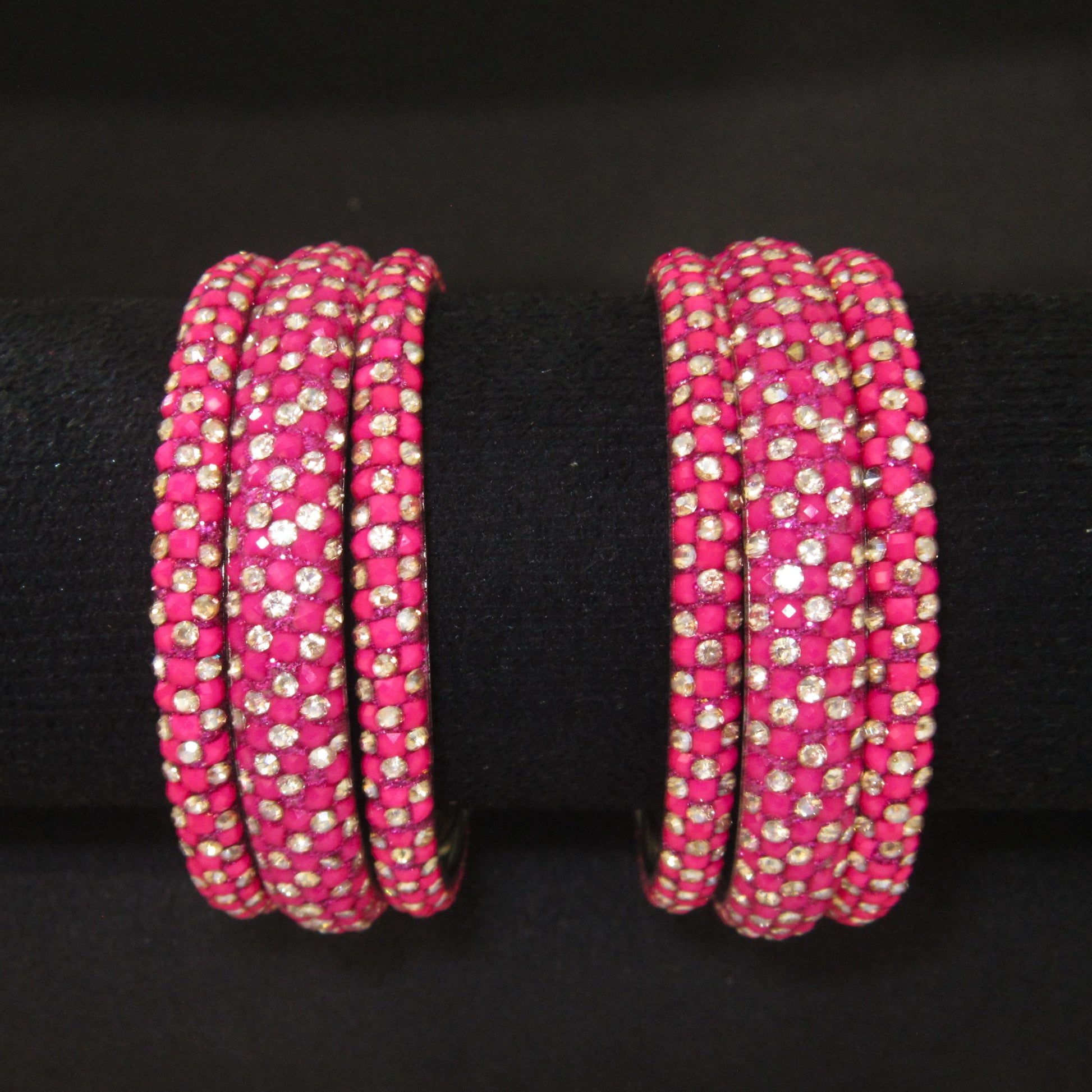 Meher Rani Pink Festive Bangle Set with 2 kada bangles and 4 side bangles featuring rani pink detailing, golden accents and sparkling stones by ENAVA