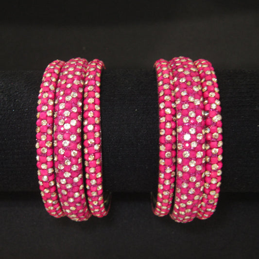 Meher Rani Pink Festive Bangle Set with 2 kada bangles and 4 side bangles featuring rani pink detailing, golden accents and sparkling stones by ENAVA