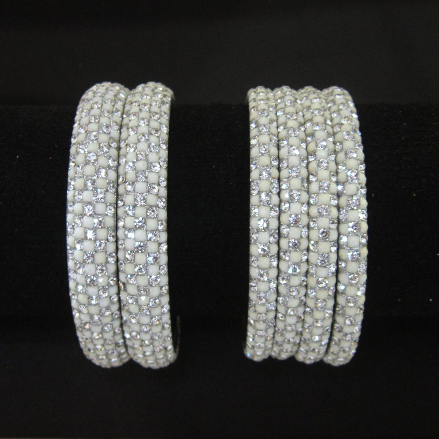 Meher White Festive Bangle Set with 2 kada bangles and 4 side bangles featuring white detailing, golden accents and sparkling stones by ENAVA
