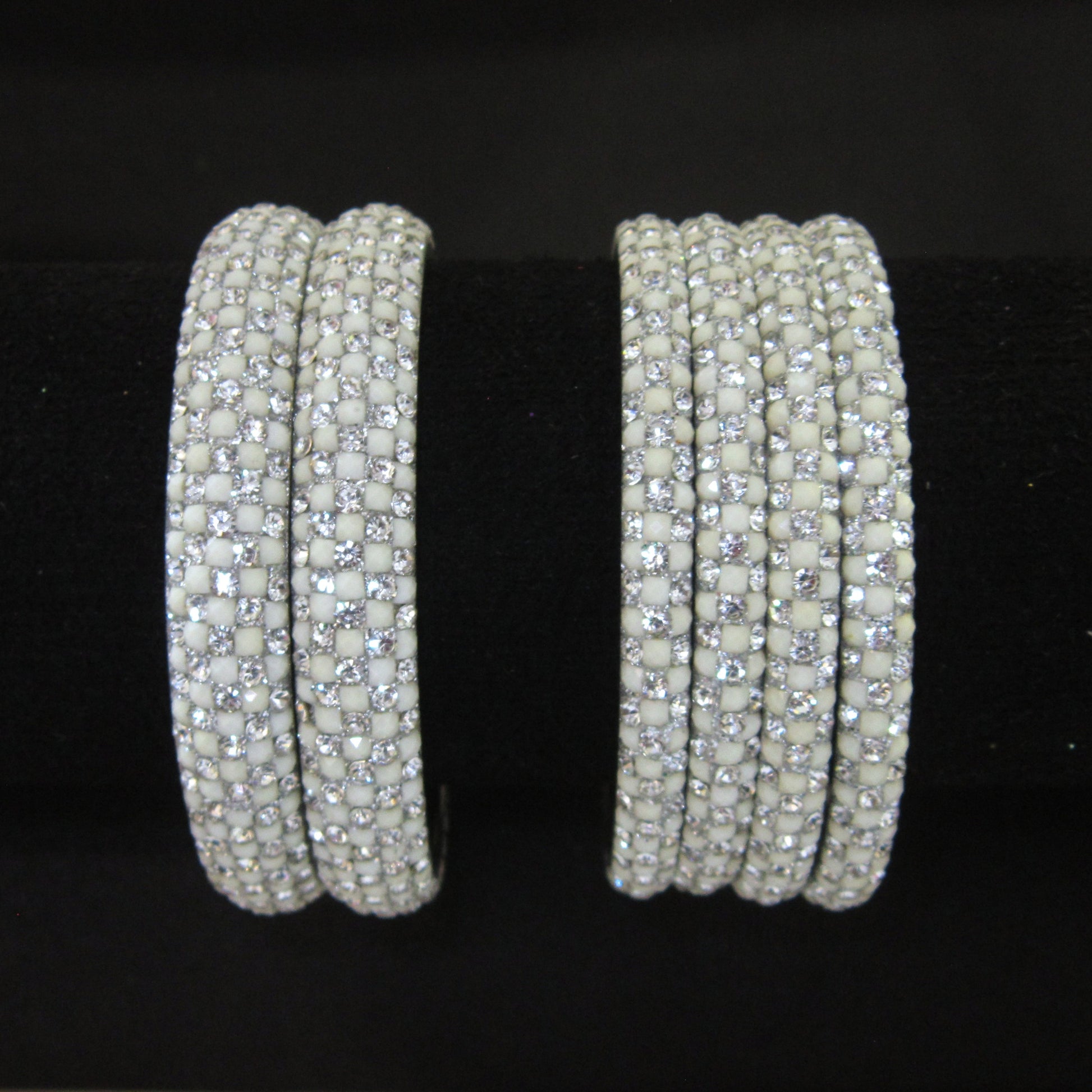Meher White Festive Bangle Set with 2 kada bangles and 4 side bangles featuring white detailing, golden accents and sparkling stones by ENAVA