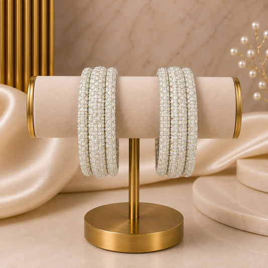 Meher White Festive Bangle Set with 2 kada bangles and 4 side bangles featuring white detailing, golden accents and sparkling stones by ENAVA