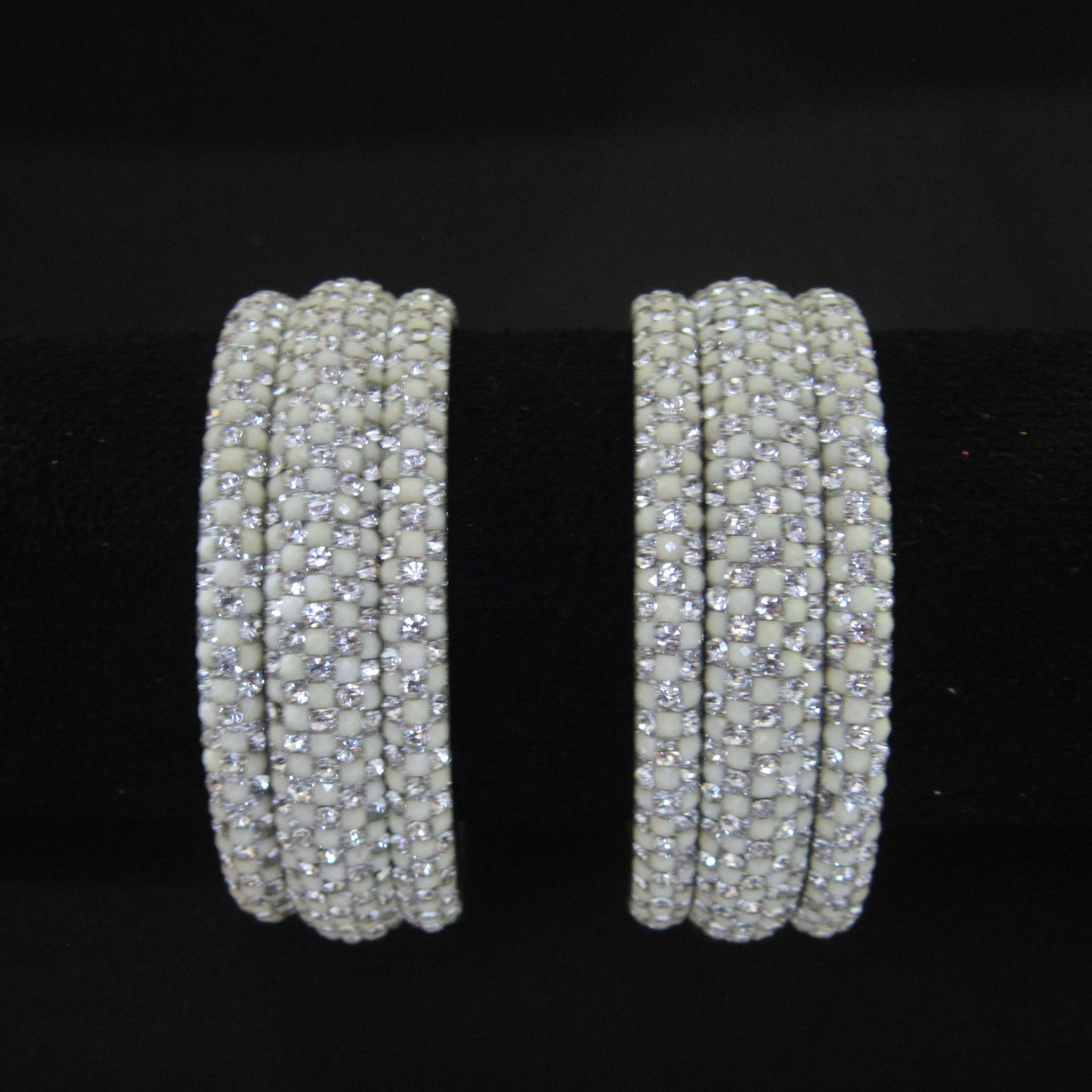 Meher White Festive Bangle Set with 2 kada bangles and 4 side bangles featuring white detailing, golden accents and sparkling stones by ENAVA