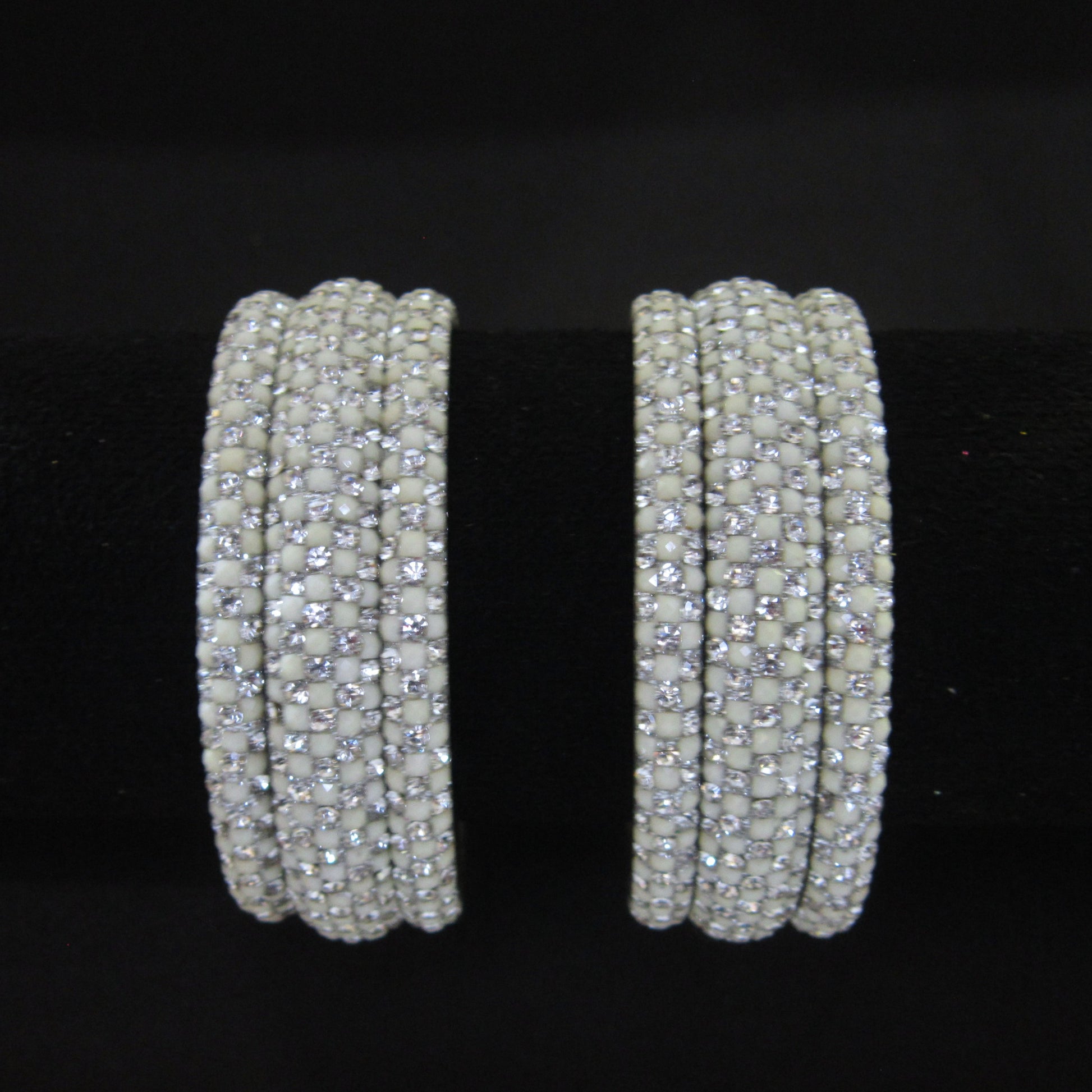 Meher White Festive Bangle Set with 2 kada bangles and 4 side bangles featuring white detailing, golden accents and sparkling stones by ENAVA