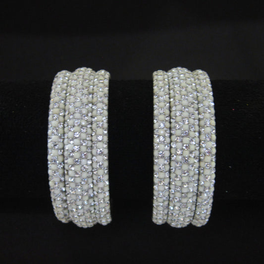 Meher White Festive Bangle Set with 2 kada bangles and 4 side bangles featuring white detailing, golden accents and sparkling stones by ENAVA