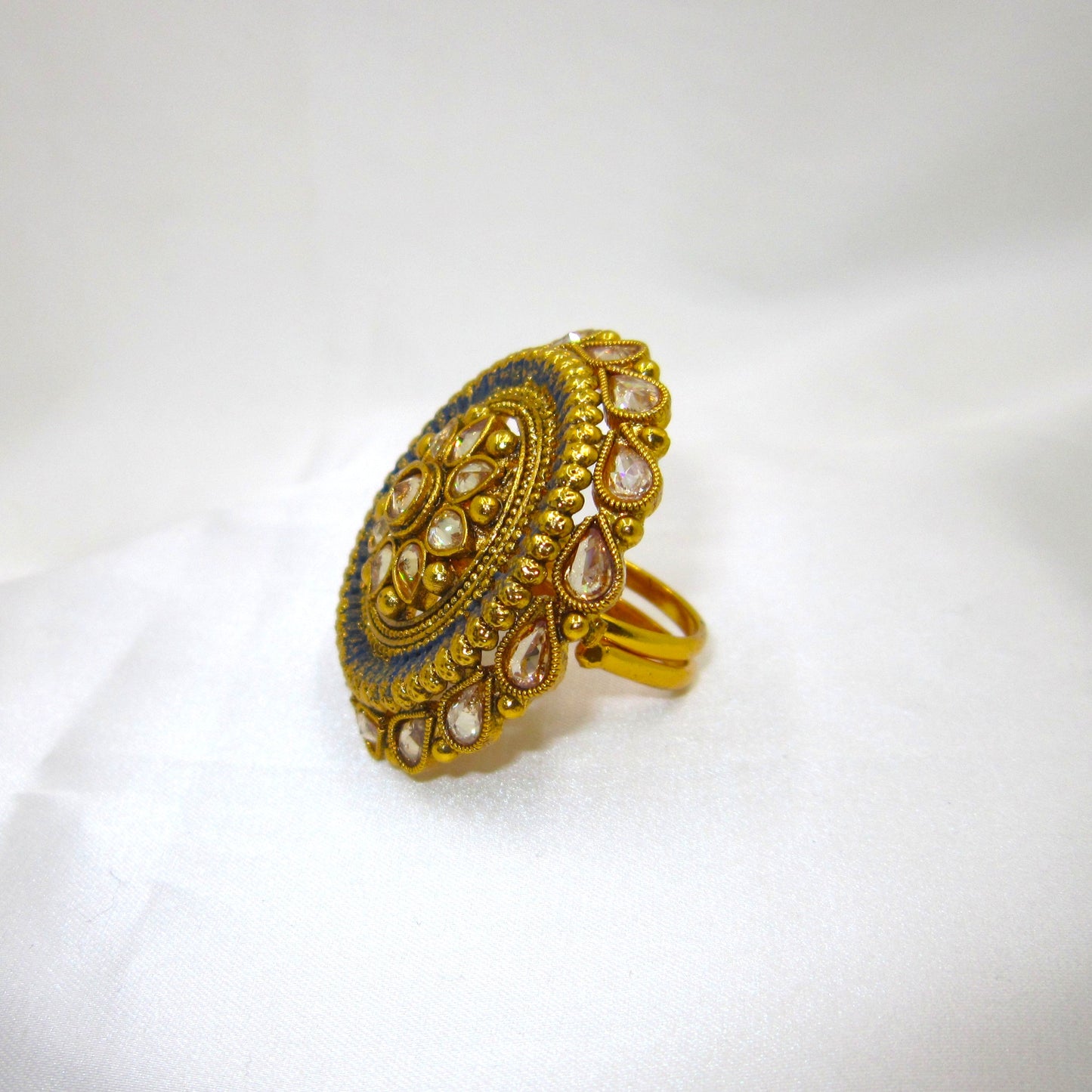 Neelam Ethnic & Traditional Antique Finish Ring by Enava featuring white kundan stones, blue enamel detailing, and antique gold finish in a Rajwadi-inspired floral statement design for ethnic and festive wear.