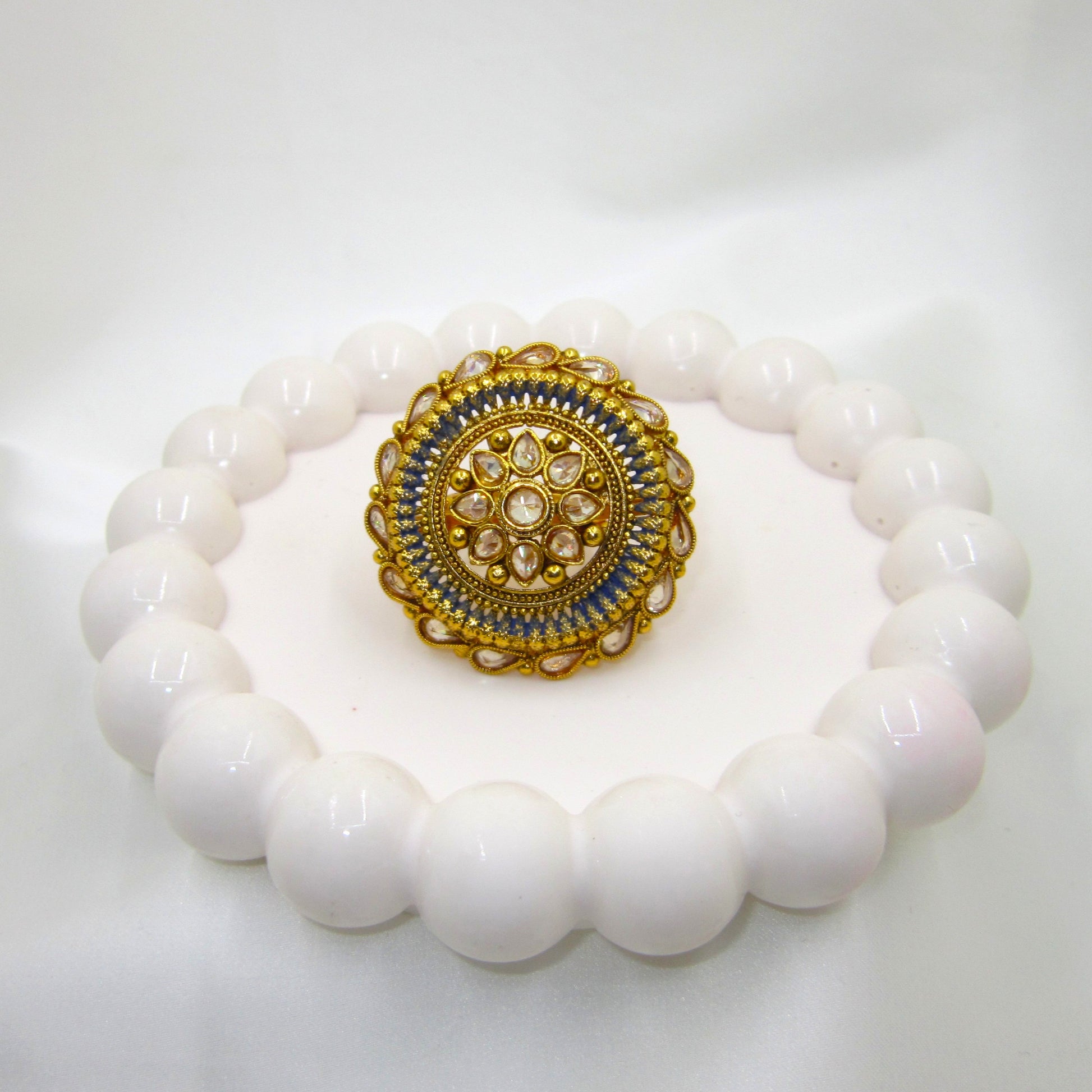 Neelam Ethnic & Traditional Antique Finish Ring by Enava featuring white kundan stones, blue enamel detailing, and antique gold finish in a Rajwadi-inspired floral statement design for ethnic and festive wear.