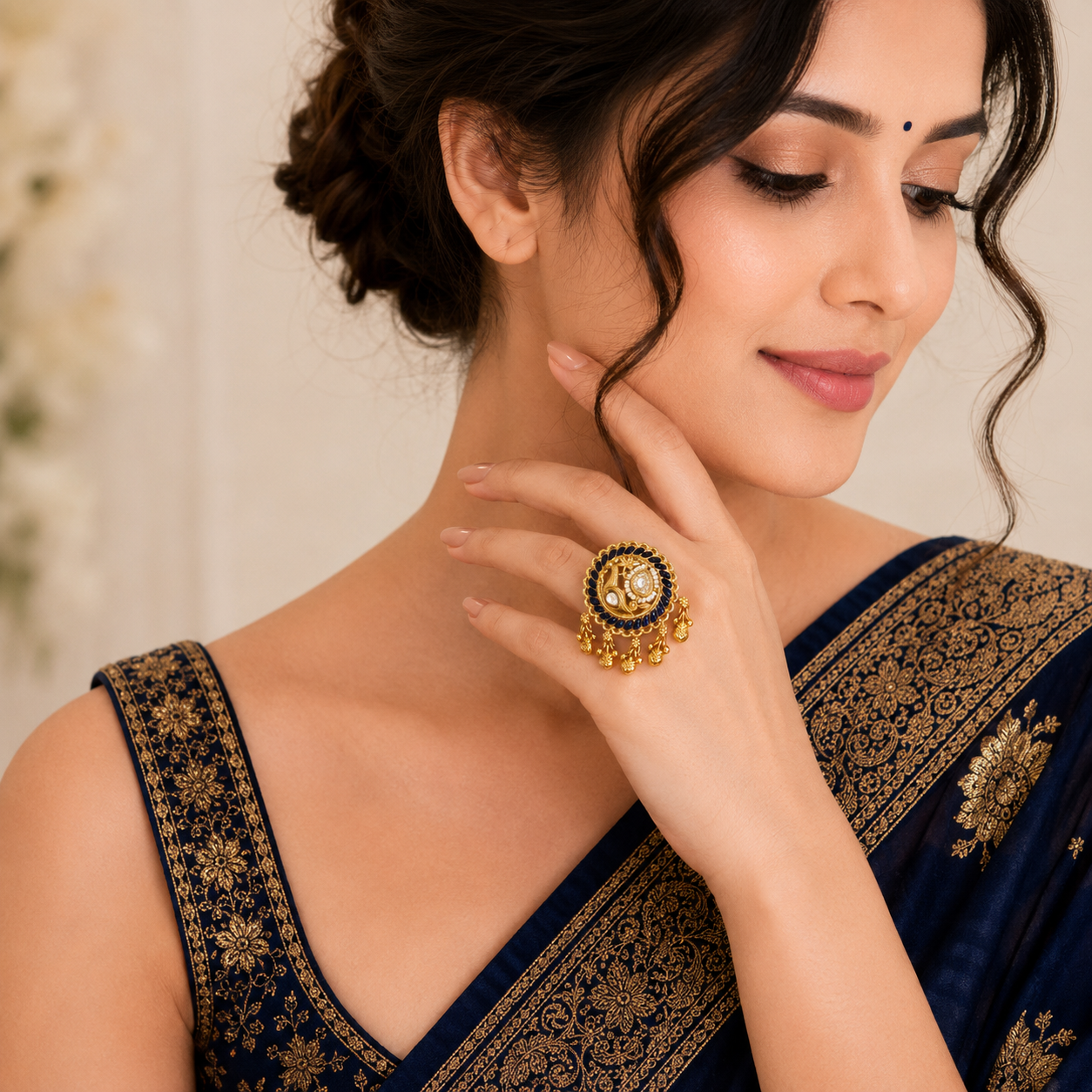 Neeltara Peacock Designer Ghungroo Statement Ring by Enava featuring an adjustable antique gold statement ring with peacock motif, royal blue enamel detailing, Kundan-inspired stones, pearl accents and decorative ghungroo charms, ideal for wedding, festive and ethnic wear.