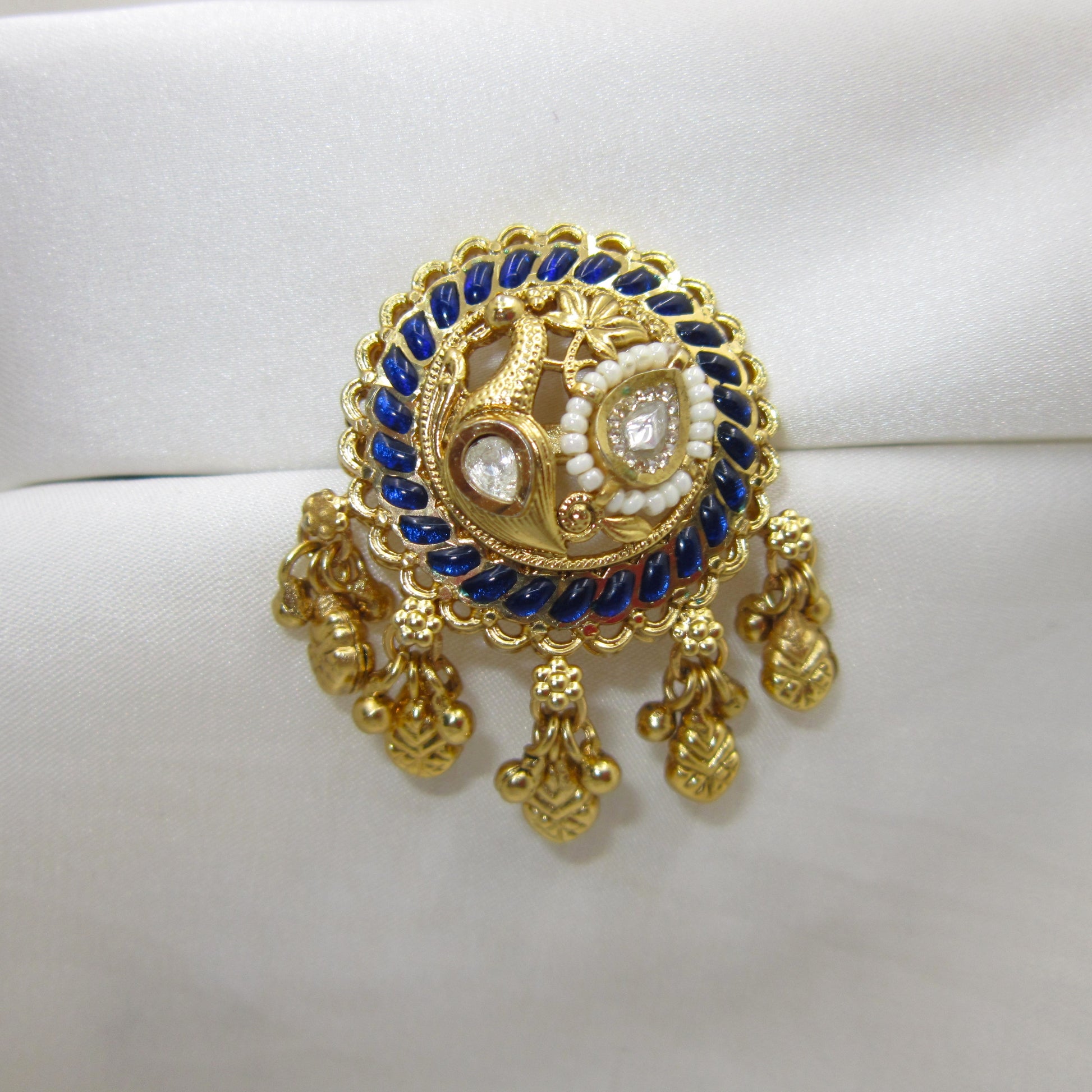 Neeltara Peacock Designer Ghungroo Statement Ring by Enava featuring an adjustable antique gold statement ring with peacock motif, royal blue enamel detailing, Kundan-inspired stones, pearl accents and decorative ghungroo charms, ideal for wedding, festive and ethnic wear.