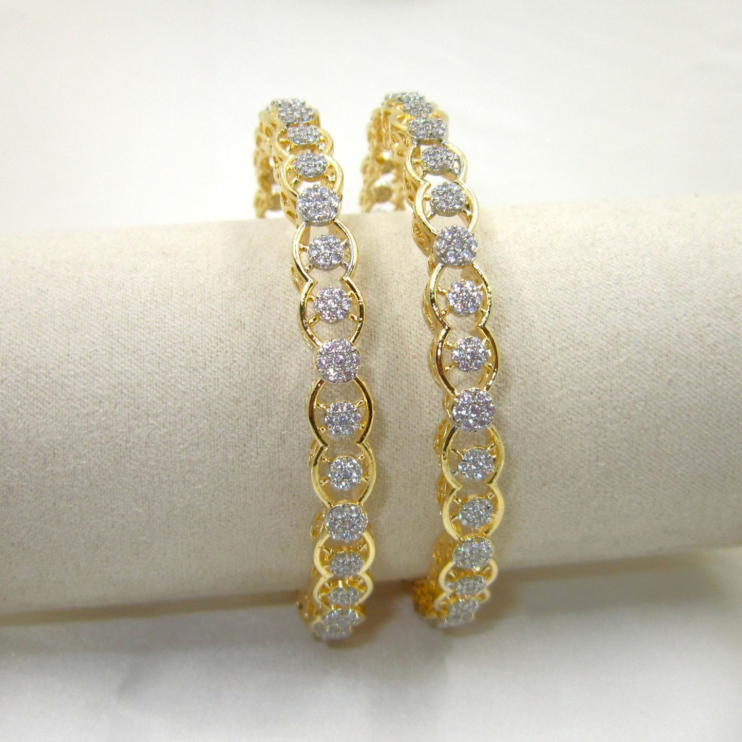 Orbit Gold Plated CZ AD Bangles by ENAVA with sparkling white Cubic Zirconia American Diamonds, premium gold plated designer AD bangles featuring an elegant orbit pattern, perfect for bridal wear, weddings, festive occasions, party wear jewellery, and ethnic fashion.