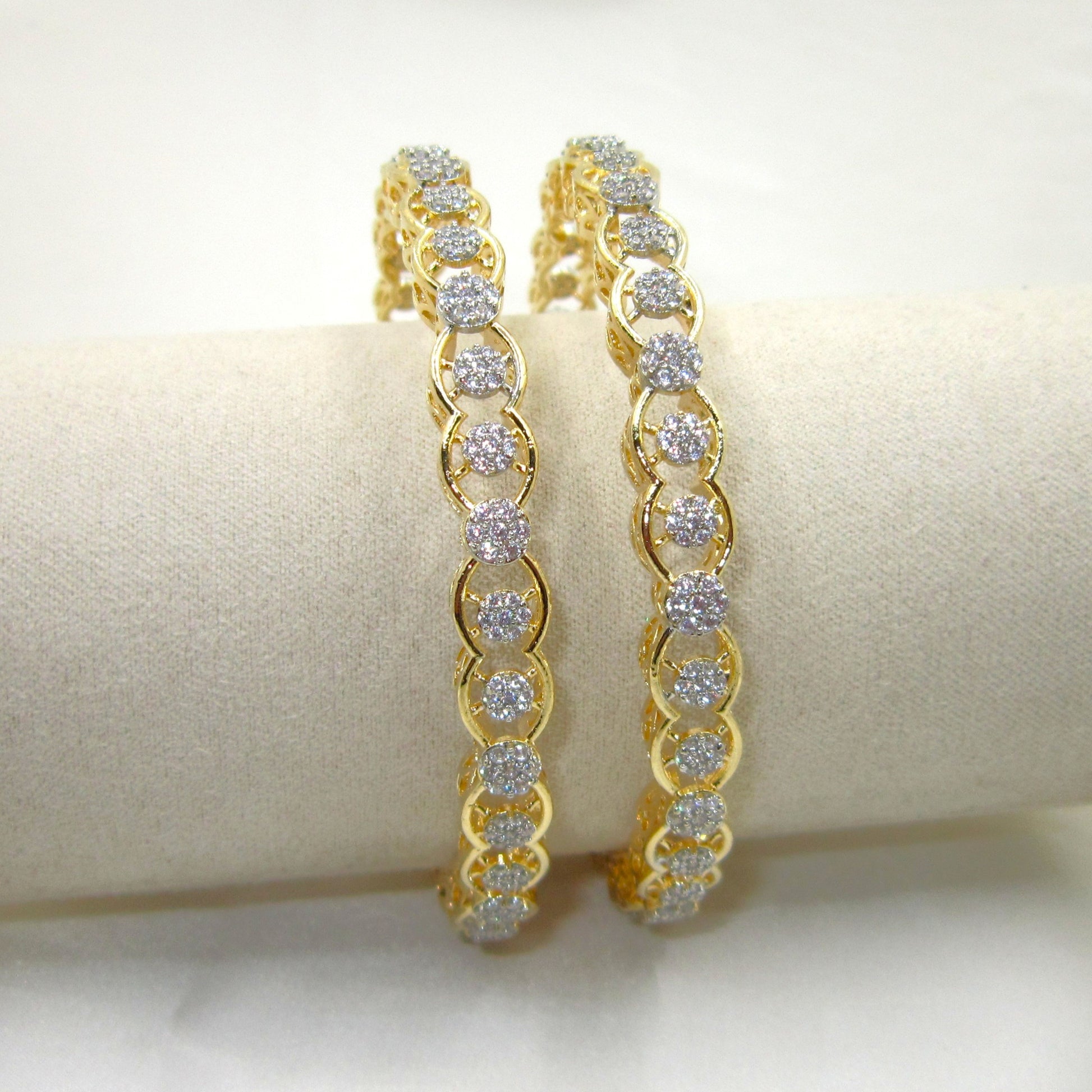 Orbit Gold Plated CZ AD Bangles by ENAVA with sparkling white Cubic Zirconia American Diamonds, premium gold plated designer AD bangles featuring an elegant orbit pattern, perfect for bridal wear, weddings, festive occasions, party wear jewellery, and ethnic fashion.
