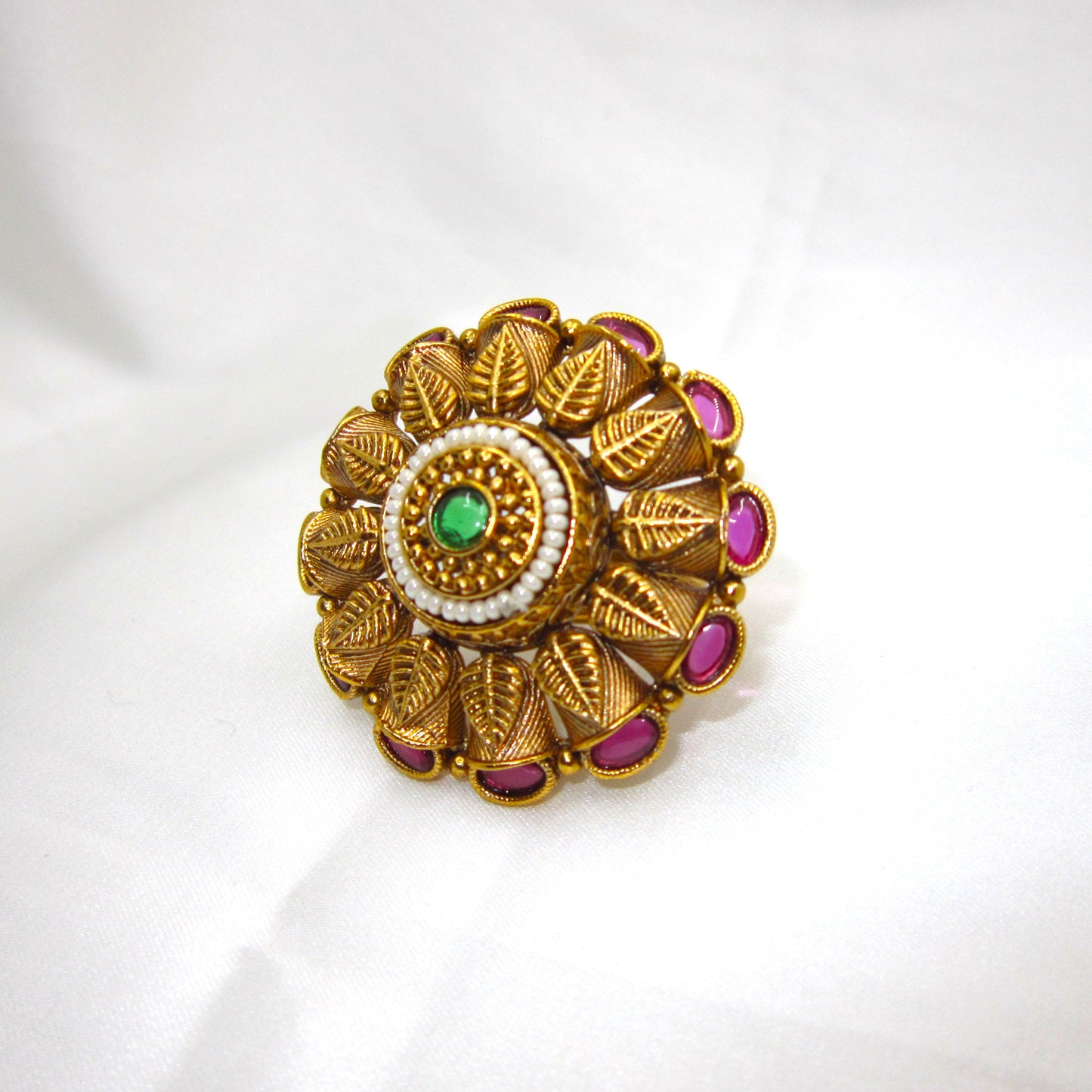 Pankhuri Pearl Heritage Ethnic Ring by Enava with engraved leaf petal design, ruby pink stones, pearl halo, green centre stone, antique gold plating, adjustable traditional statement ring for weddings and festive ethnic wear.
