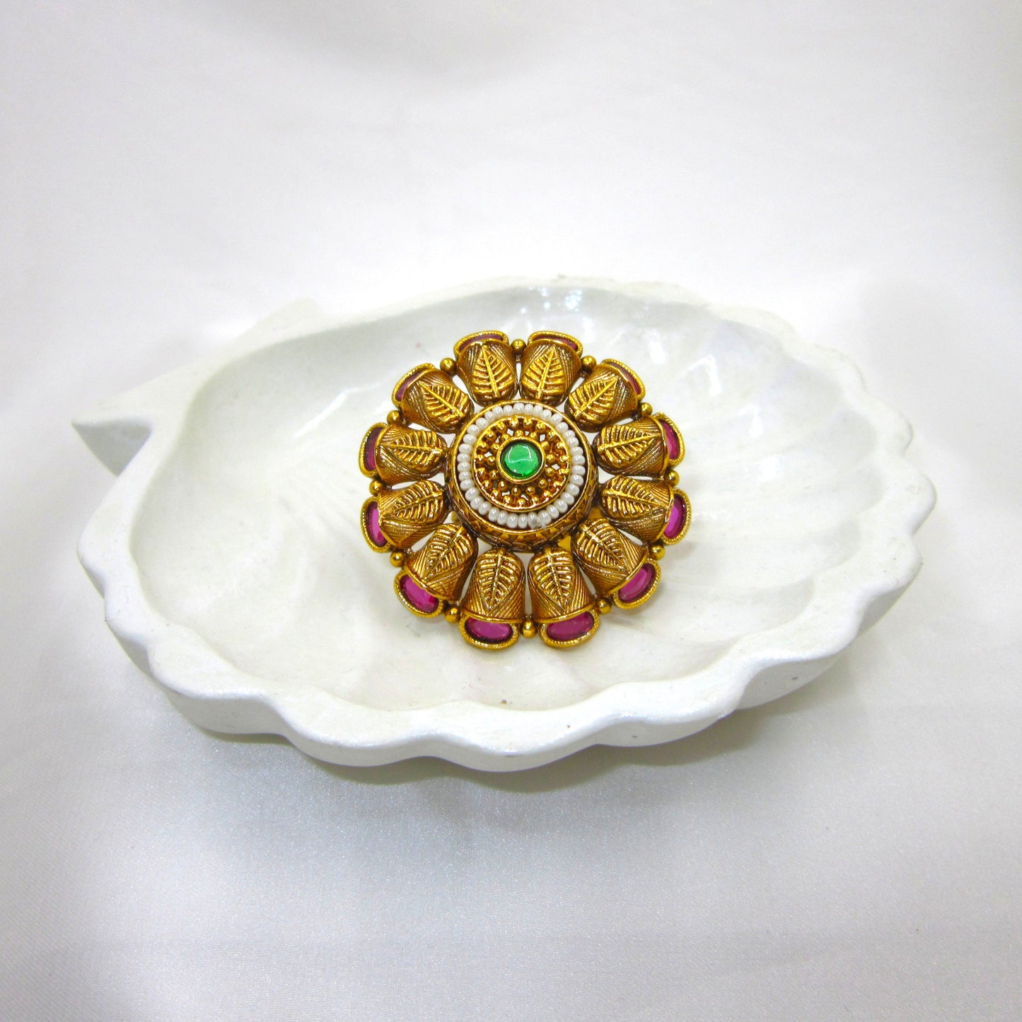 Pankhuri Pearl Heritage Ethnic Ring by Enava with engraved leaf petal design, ruby pink stones, pearl halo, green centre stone, antique gold plating, adjustable traditional statement ring for weddings and festive ethnic wear.