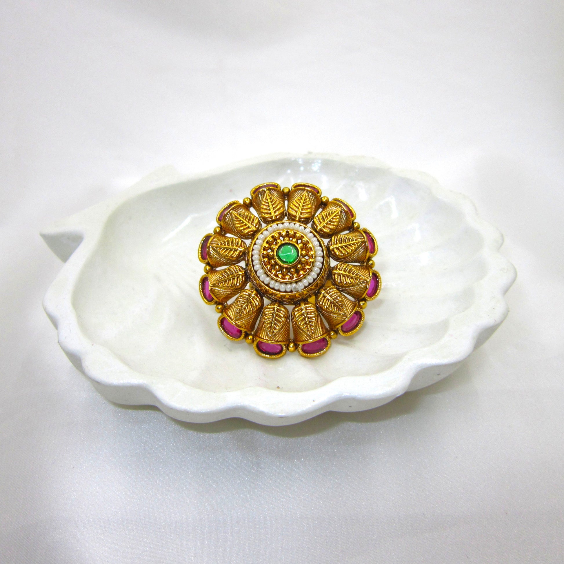 Pankhuri Pearl Heritage Ethnic Ring by Enava with engraved leaf petal design, ruby pink stones, pearl halo, green centre stone, antique gold plating, adjustable traditional statement ring for weddings and festive ethnic wear.