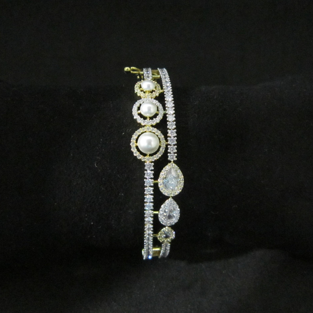 Pearl Oasis AD Bracelet with pearls, sparkling American Diamond stones and drop-shaped center AD in dual-tone finish, designer pearl bracelet for women by ENAVA.