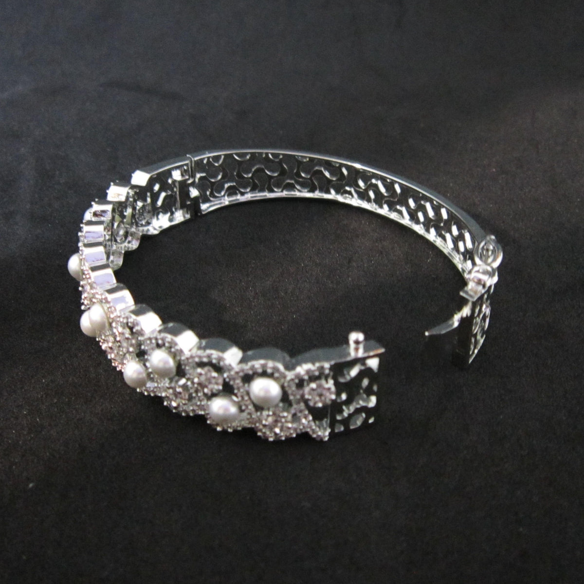Pearlora AD Pearl Designer Silver Bracelet with AD stones and white pearls, silver-tone designer bracelet by ENAVA for women.