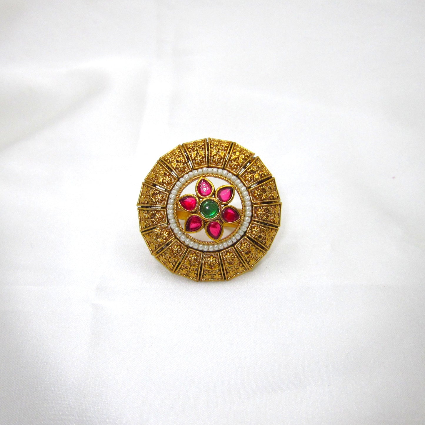 Pushpika Heritage Floral Antique Golden Finish Ethnic Ring by Enava featuring ruby pink teardrop glass stones, emerald green centre stone, pearl bead detailing, intricate floral motif, adjustable statement ring for weddings, festive wear, and traditional ethnic jewellery.