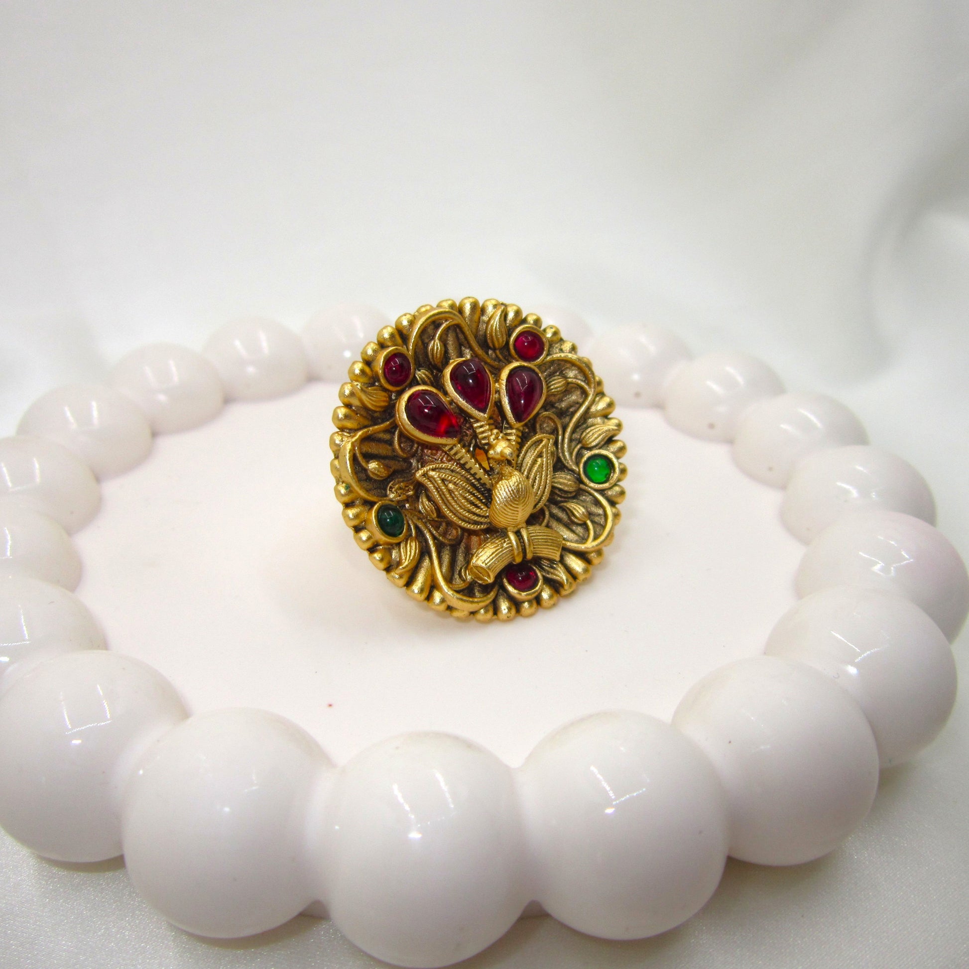 Rajmayuri Heritage Antique Golden Finish Ethnic Ring by Enava featuring a handcrafted 3D peacock design with antique gold finish, ruby-red and emerald-green stones, premium statement ethnic ring for bridal, festive, wedding, and traditional wear.