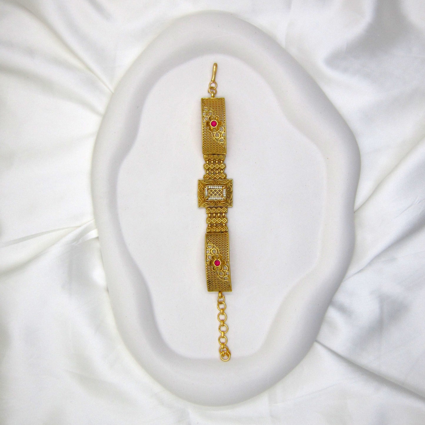 Traditional Rajwadi bracelet by ENAVA featuring antique gold detailing, pearl-inspired centerpiece, heritage craftsmanship, and luxury bridal jewellery aesthetics.
