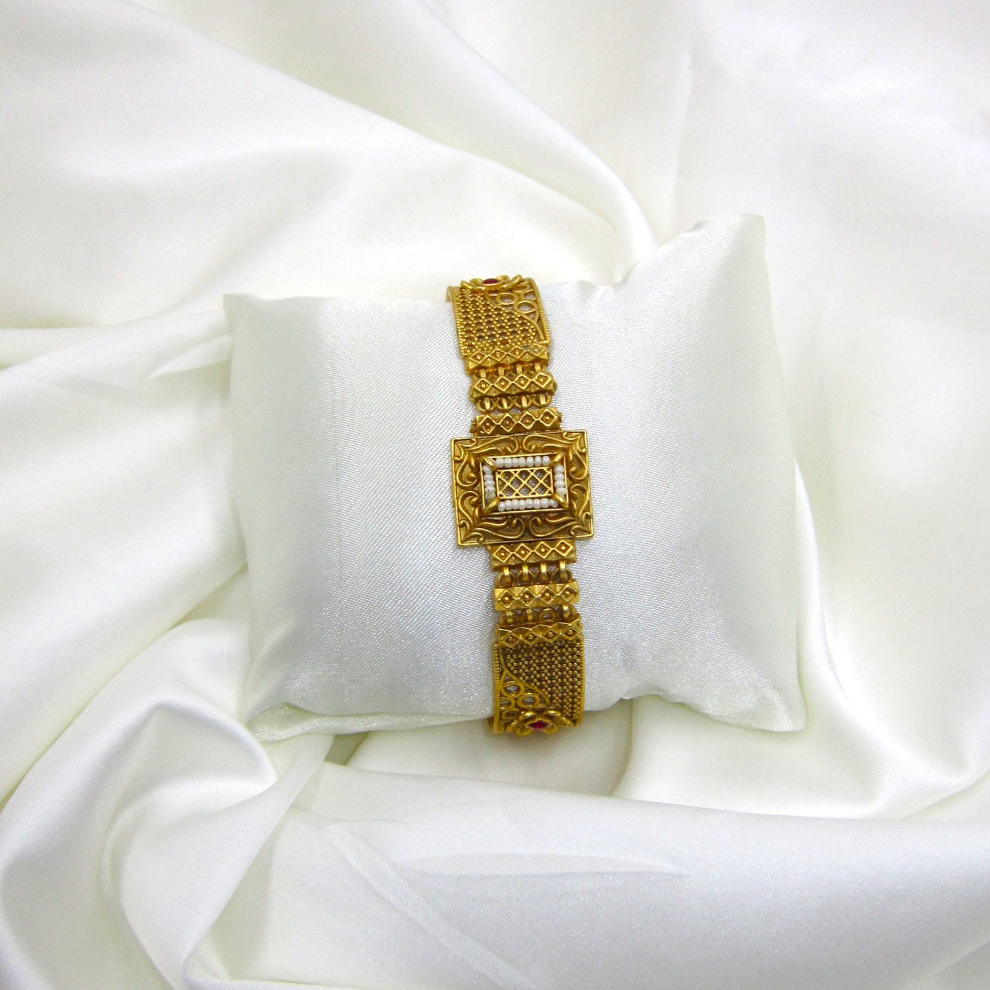 Traditional Rajwadi bracelet by ENAVA featuring antique gold detailing, pearl-inspired centerpiece, heritage craftsmanship, and luxury bridal jewellery aesthetics.
