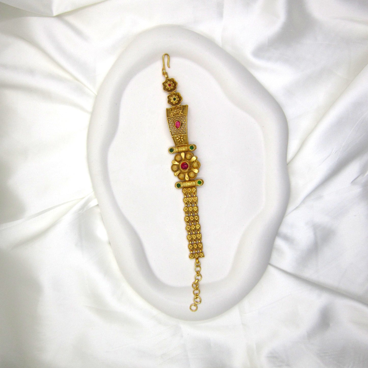 Heritage Blossom Rajwadi Antique Bracelet by ENAVA featuring a floral centerpiece, antique gold finish, ruby and emerald-inspired stone accents, traditional Rajwadi heritage jewellery bracelet for weddings, Mehendi, Sangeet, festivals, and ethnic celebrations.