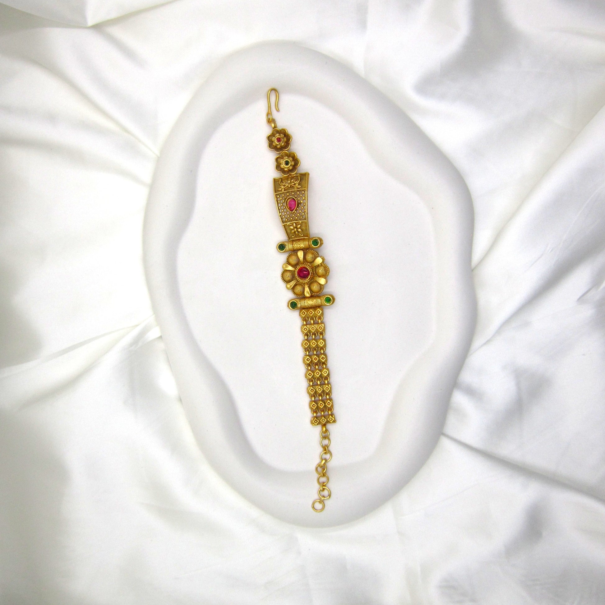 Heritage Blossom Rajwadi Antique Bracelet by ENAVA featuring a floral centerpiece, antique gold finish, ruby and emerald-inspired stone accents, traditional Rajwadi heritage jewellery bracelet for weddings, Mehendi, Sangeet, festivals, and ethnic celebrations.