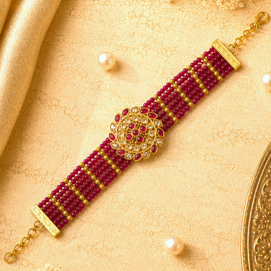 Ruhanika Ruby Pink Ethnic Bracelet by Enava featuring multi-strand ruby pink crystal beads, antique gold floral centerpiece, American Diamond detailing, adjustable chain closure, handcrafted ethnic design, and a premium statement bracelet for weddings, festive occasions, traditional wear, and party styling.