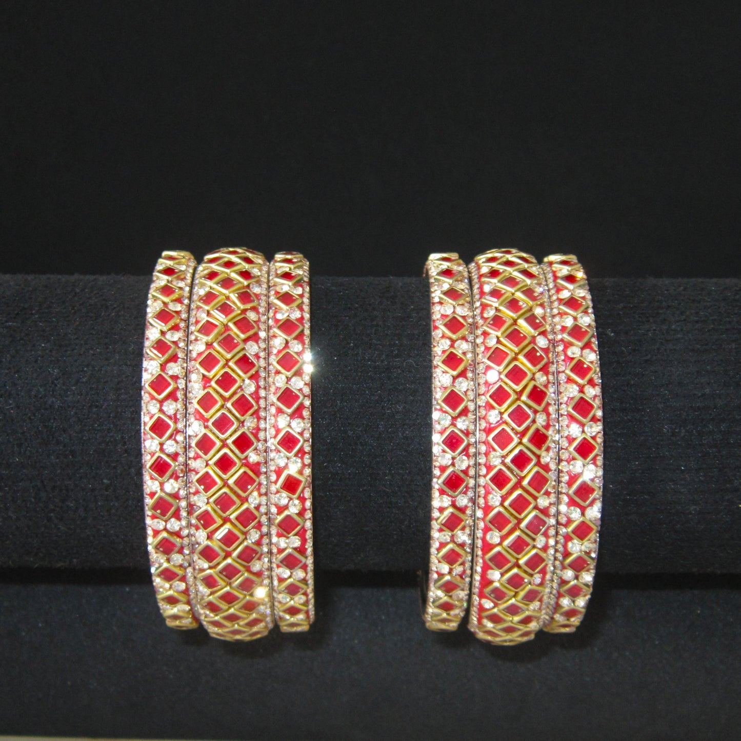Sitara Red Festive Bangle Set with 2 kada bangles and 4 side bangles featuring vibrant red detailing, golden latticework and sparkling stones by ENAVA
