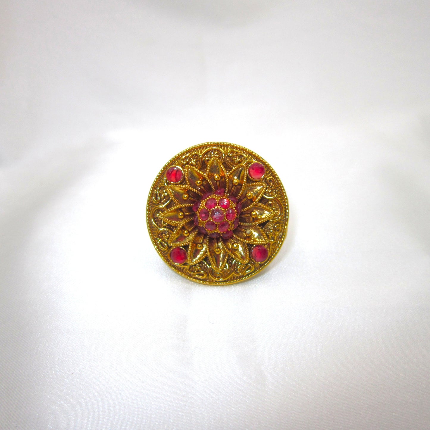 Swarna Petals Ruby Pink Antique Finish Ring by Enava featuring a handcrafted floral sunburst design with antique gold finish and ruby pink stones, traditional ethnic statement ring for women, ideal for weddings, festive wear, Rajwadi jewellery, and bridal accessories.