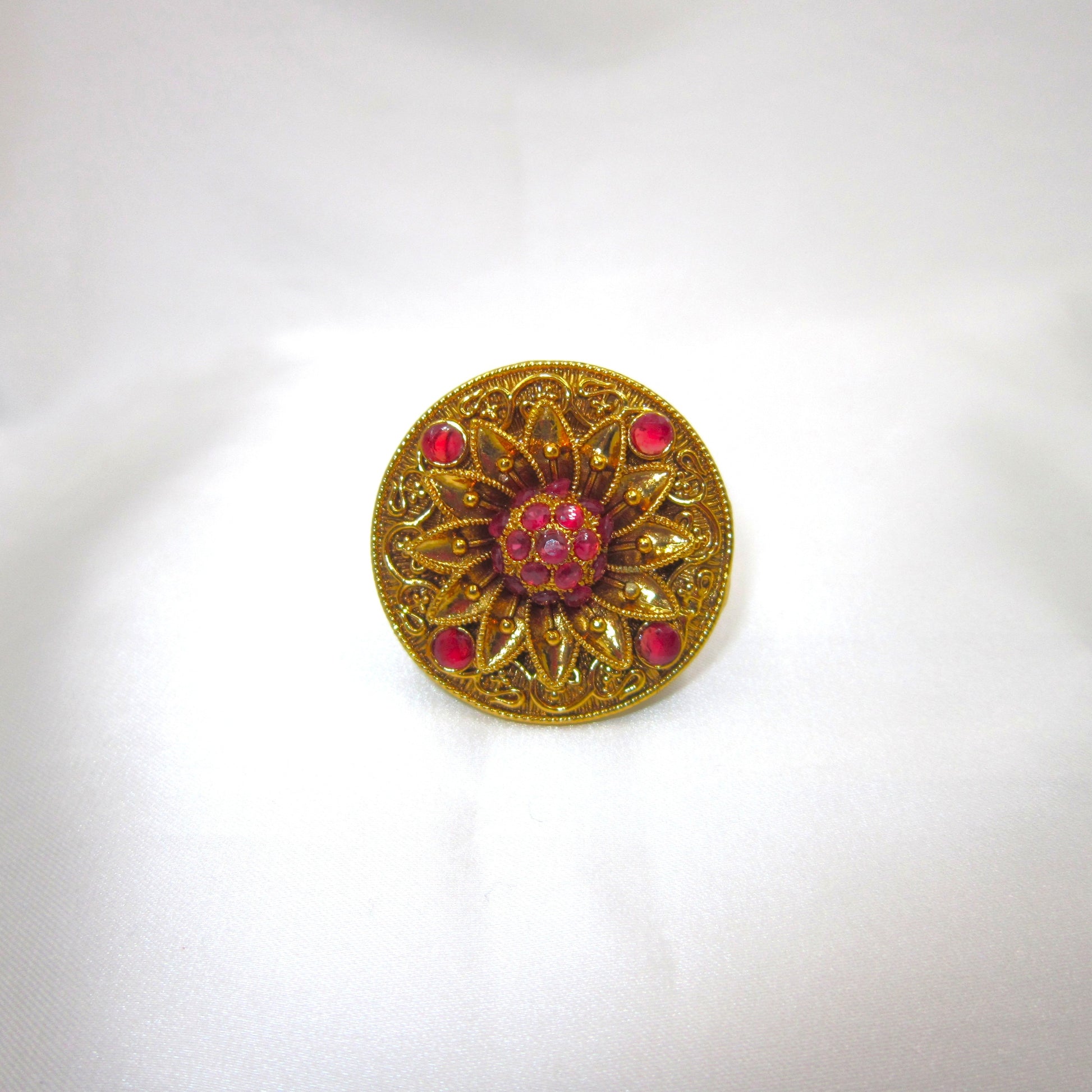 Swarna Petals Ruby Pink Antique Finish Ring by Enava featuring a handcrafted floral sunburst design with antique gold finish and ruby pink stones, traditional ethnic statement ring for women, ideal for weddings, festive wear, Rajwadi jewellery, and bridal accessories.