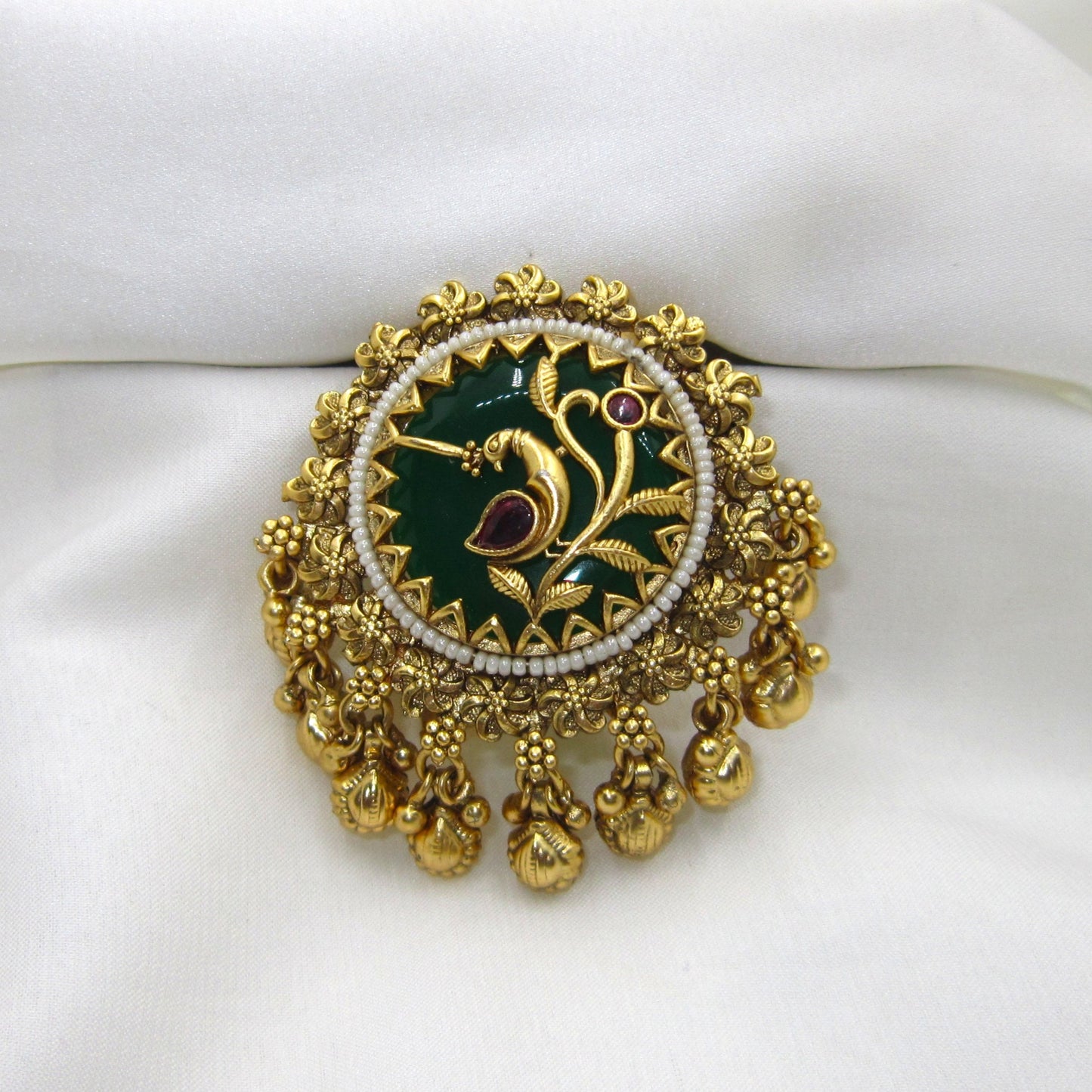 Vanmayuri Heritage Antique Emerald Green Ghungroo Ring by Enava featuring an adjustable antique gold statement ring with emerald green enamel, floral vine design, pearl border and decorative ghungroo charms, perfect for wedding jewellery, festive wear and traditional ethnic outfits.
